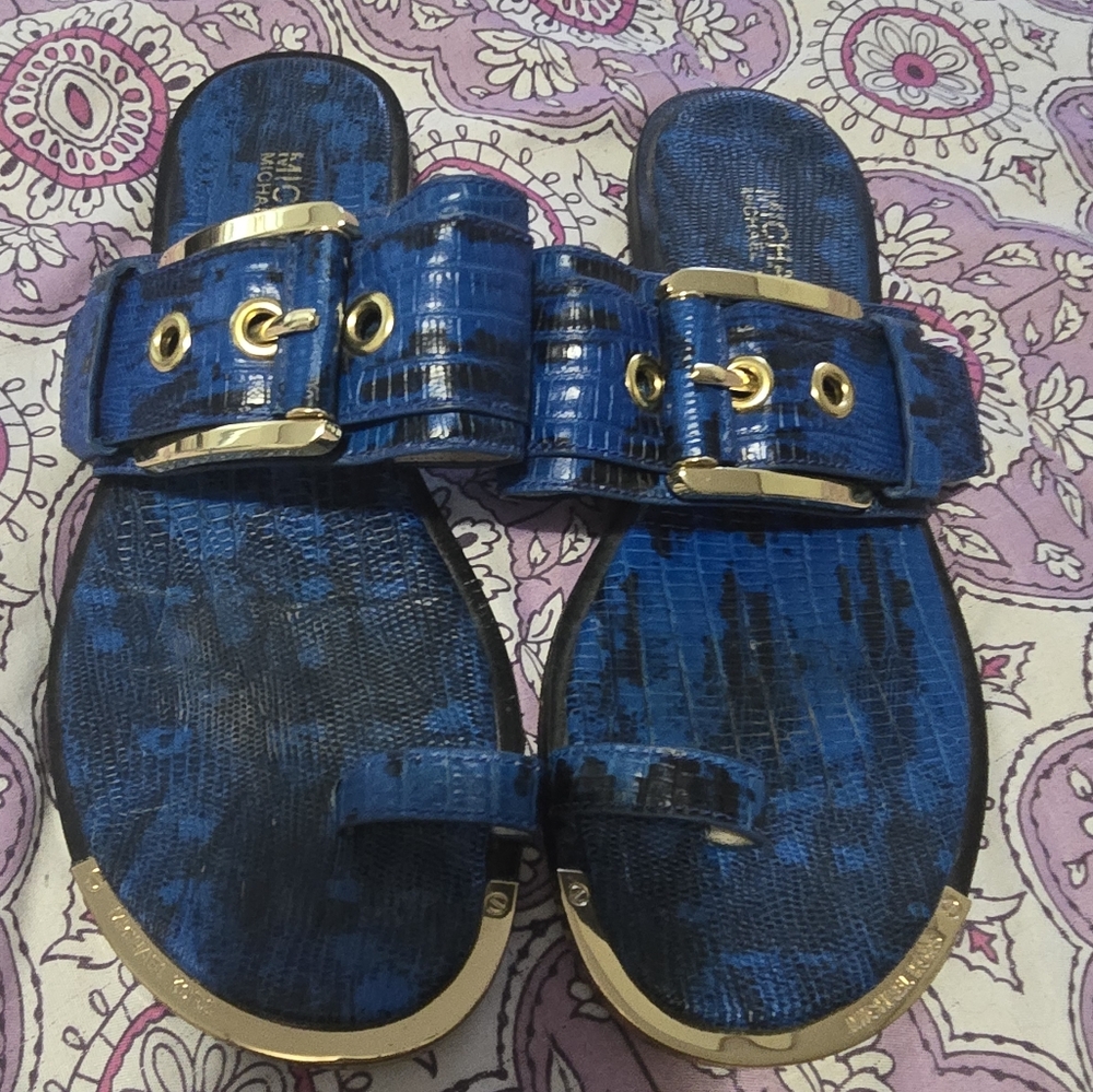 Size 7M Michael Kors Royal Blue Sandals with Black And Gold Colored Accents.